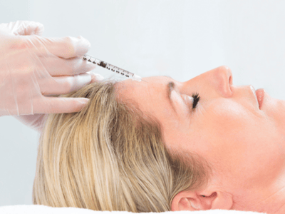 Patient getting an injection in the forehead